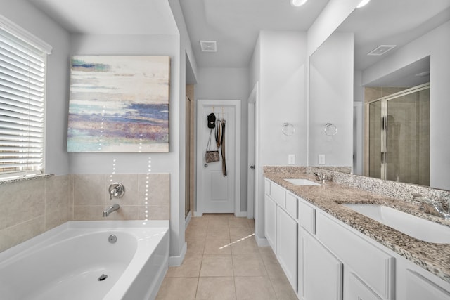 bathroom featuring vanity, independent shower and bath, and tile patterned flooring