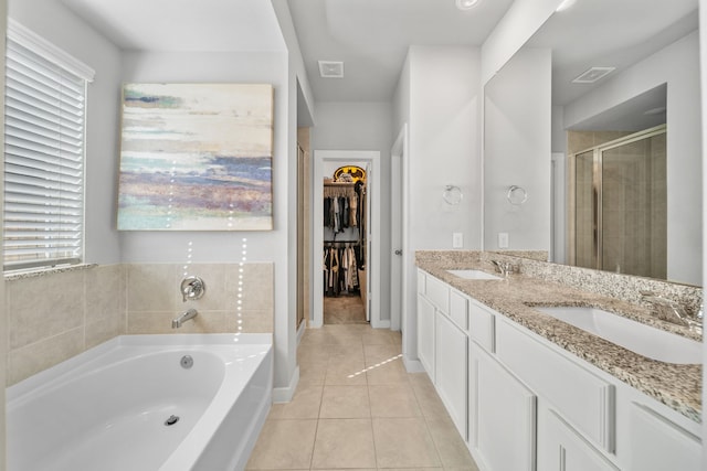 bathroom featuring vanity, tile patterned floors, and separate shower and tub