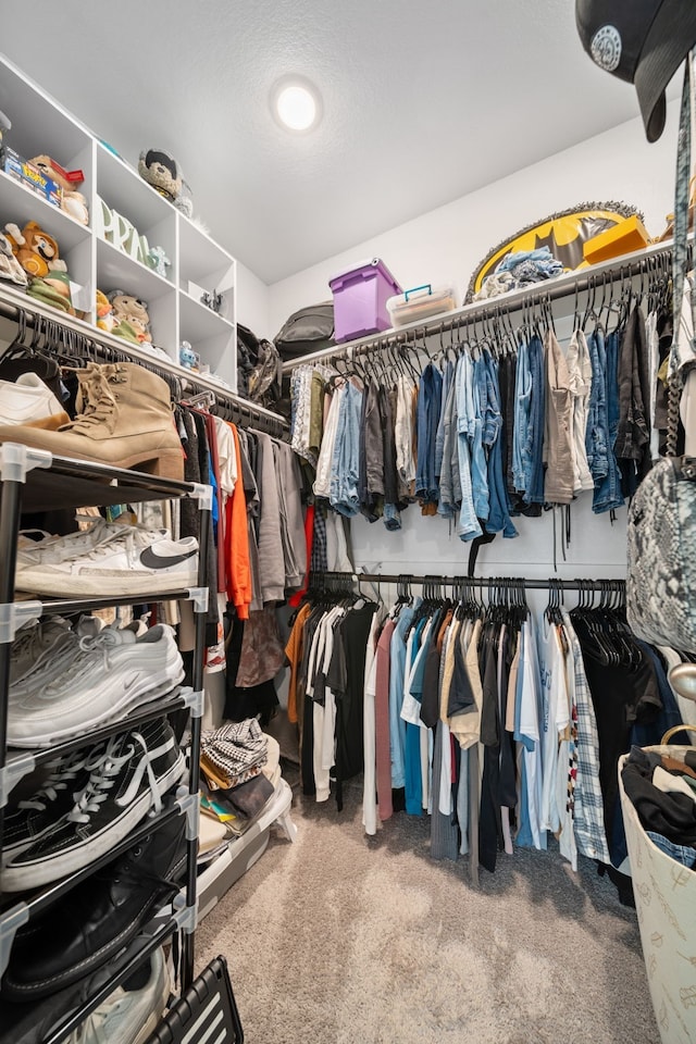 walk in closet with carpet