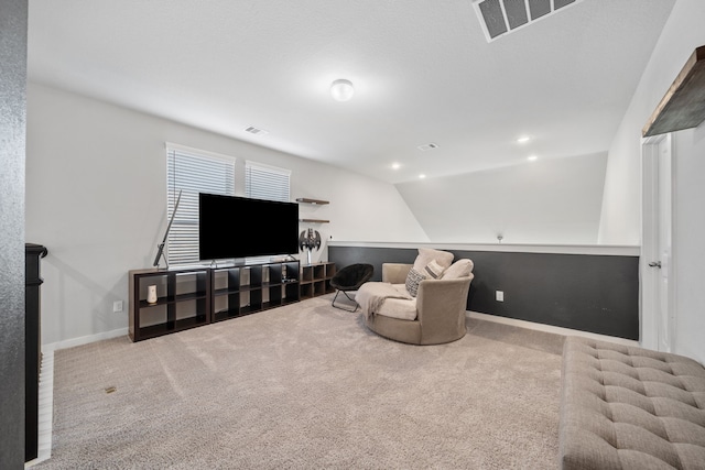 sitting room with carpet flooring and vaulted ceiling