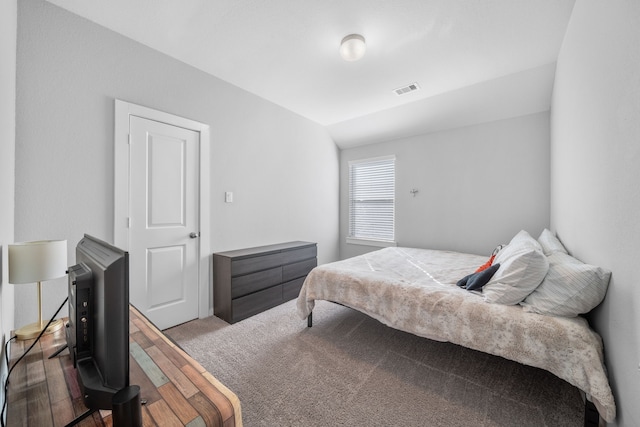 bedroom featuring lofted ceiling and hardwood / wood-style floors