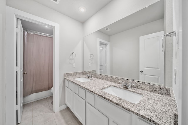 bathroom featuring vanity, tile patterned floors, and toilet