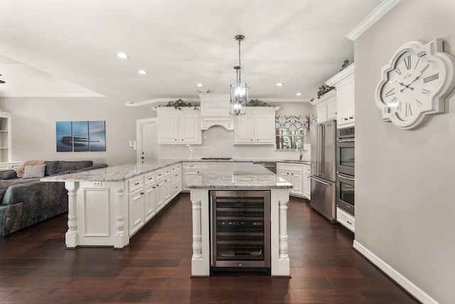 kitchen featuring crown molding, stainless steel appliances, wine cooler, white cabinets, and decorative light fixtures