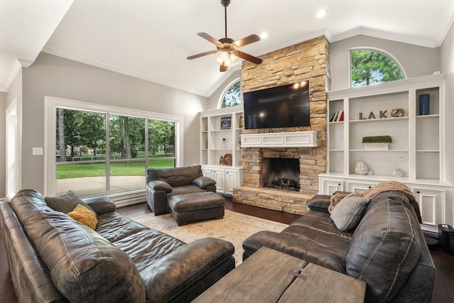 living room featuring high vaulted ceiling, a fireplace, ornamental molding, ceiling fan, and light hardwood / wood-style flooring