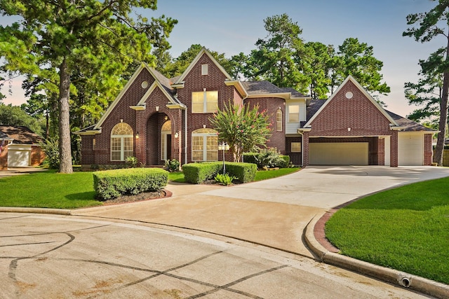 view of front of property featuring a garage and a front lawn