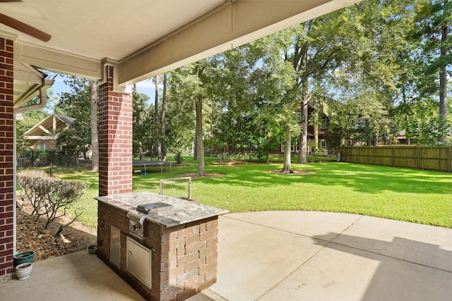 view of patio featuring area for grilling and a trampoline