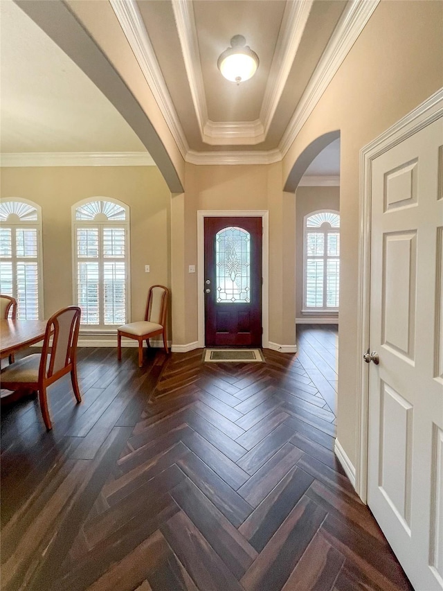 foyer featuring a tray ceiling, crown molding, and dark parquet floors