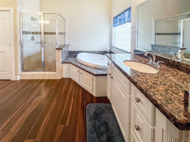 bathroom featuring shower with separate bathtub and vanity