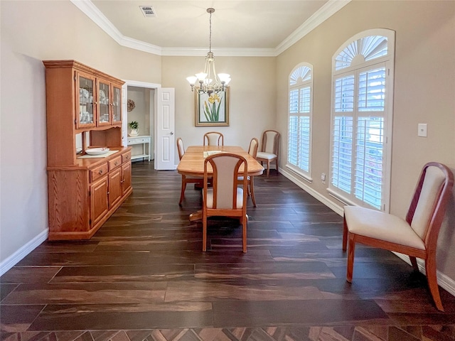 dining space featuring dark wood-type flooring, crown molding, and a chandelier