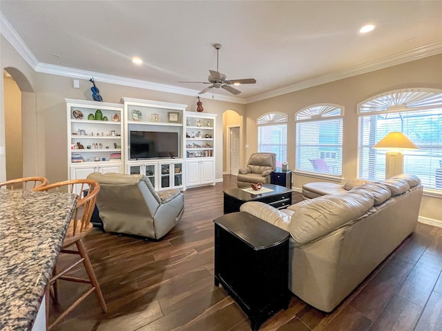 living room featuring dark hardwood / wood-style flooring, ornamental molding, and ceiling fan