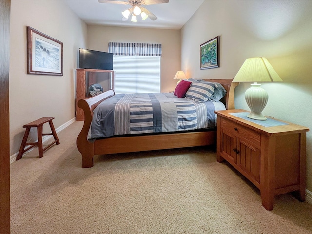 bedroom featuring light colored carpet and ceiling fan