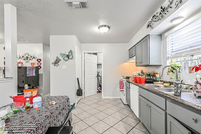 kitchen with sink, gray cabinetry, range, white dishwasher, and a textured ceiling