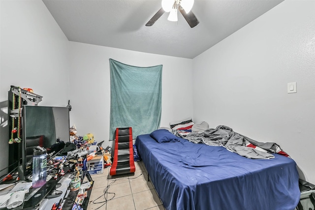 bedroom with ceiling fan and light tile patterned flooring