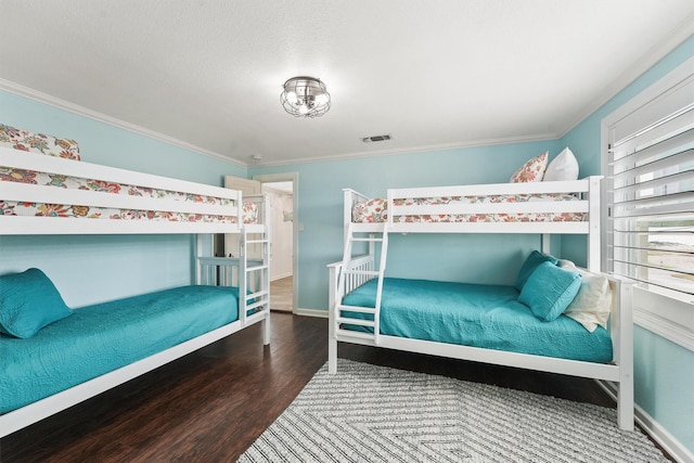 bedroom featuring ornamental molding and wood-type flooring