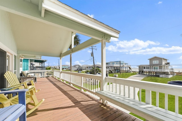 wooden deck with a lawn