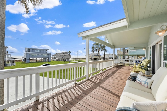 wooden deck with a lawn