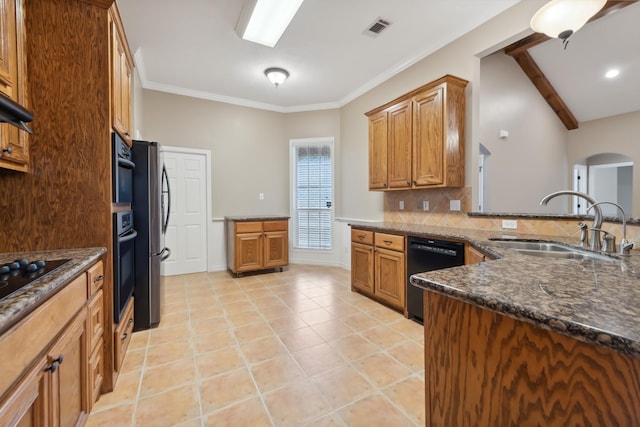 kitchen featuring sink, light tile patterned floors, dark stone countertops, black appliances, and decorative backsplash