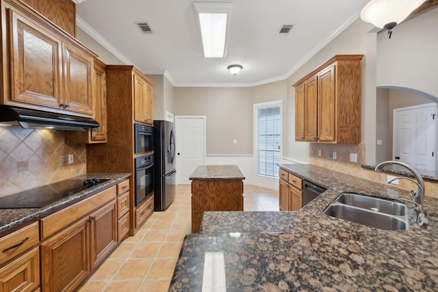 kitchen featuring sink, light tile patterned floors, dark stone countertops, ornamental molding, and black appliances