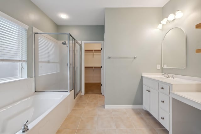 bathroom featuring tile patterned flooring, vanity, and shower with separate bathtub