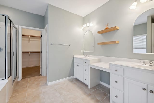 bathroom featuring vanity, tile patterned flooring, and a shower with shower door