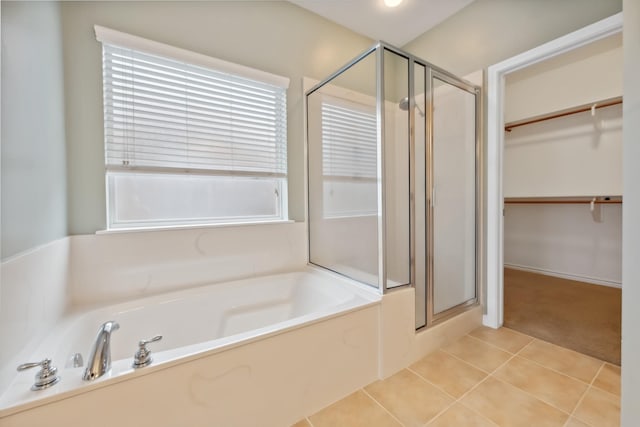 bathroom featuring tile patterned floors and separate shower and tub