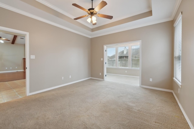 unfurnished room with crown molding, ceiling fan, a raised ceiling, and light carpet