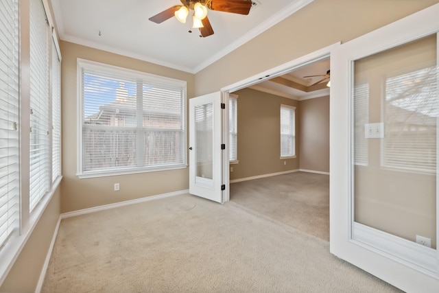 unfurnished bedroom featuring crown molding, light colored carpet, and ceiling fan