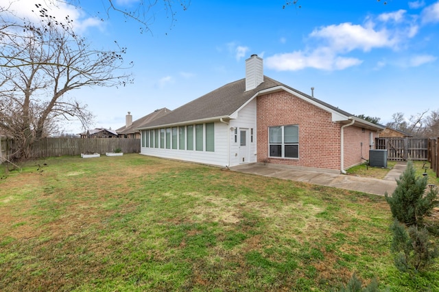 rear view of property featuring a yard, a patio area, and central air condition unit