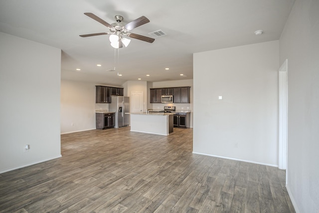 unfurnished living room with ceiling fan and dark hardwood / wood-style floors