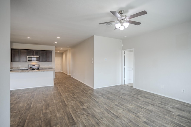 unfurnished living room with dark hardwood / wood-style floors and ceiling fan