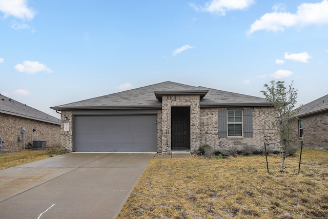 view of front of house featuring a garage, central AC unit, and a front lawn