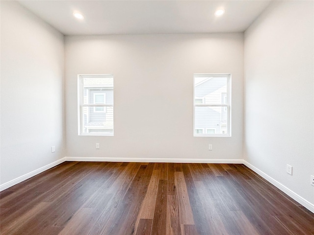 unfurnished room with dark hardwood / wood-style flooring