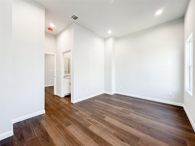 spare room with dark hardwood / wood-style flooring