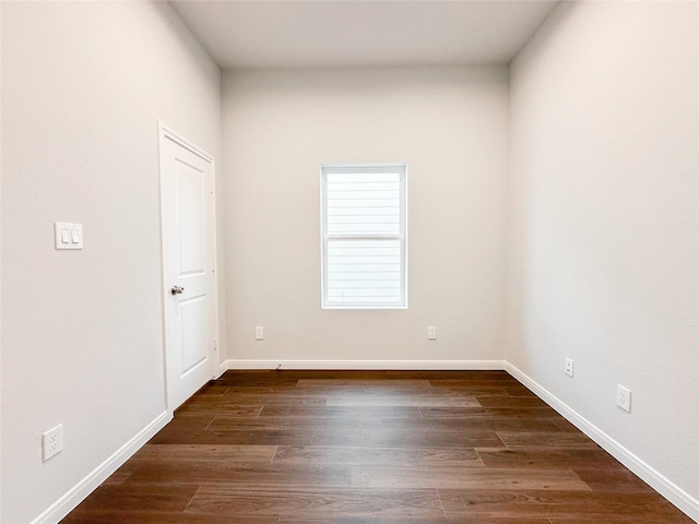 empty room featuring dark hardwood / wood-style flooring