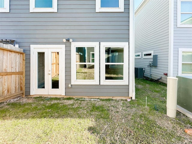 doorway to property featuring french doors and a lawn