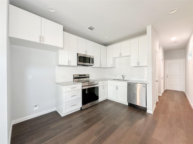 kitchen with white cabinetry, sink, dark wood-type flooring, and appliances with stainless steel finishes