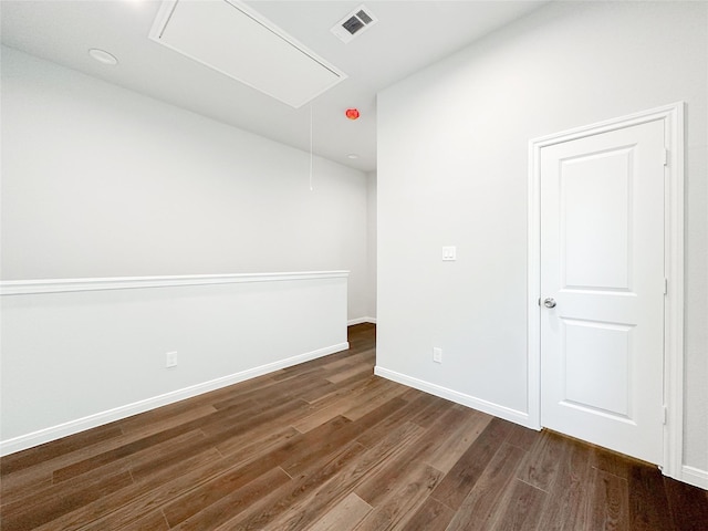 unfurnished room with dark hardwood / wood-style flooring