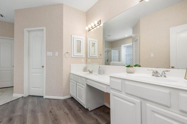 bathroom featuring a shower with door, vanity, and hardwood / wood-style floors