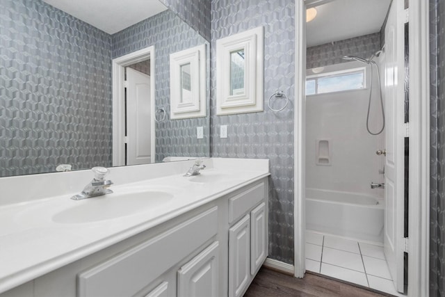 bathroom with tile patterned flooring, vanity, and washtub / shower combination