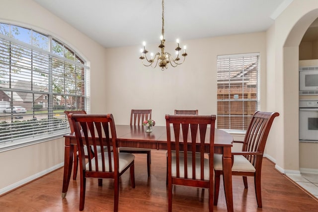 dining room with an inviting chandelier and hardwood / wood-style floors