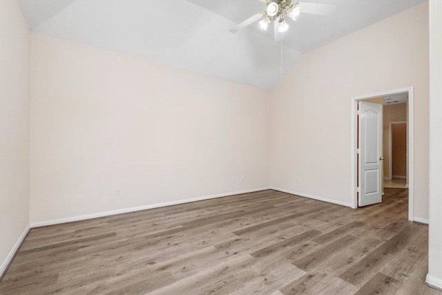 unfurnished room featuring ceiling fan, vaulted ceiling, and light wood-type flooring