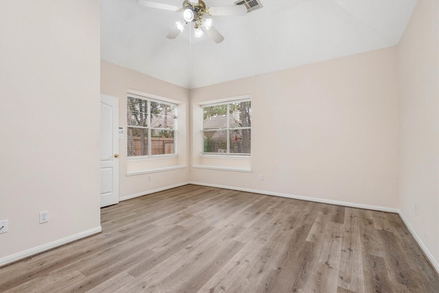 empty room featuring ceiling fan, light hardwood / wood-style floors, and vaulted ceiling