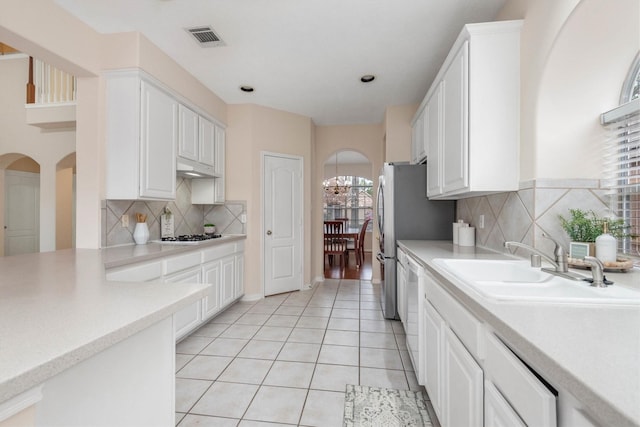 kitchen featuring white cabinetry, sink, and white appliances