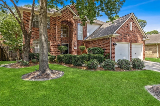 view of front property with a garage and a front lawn