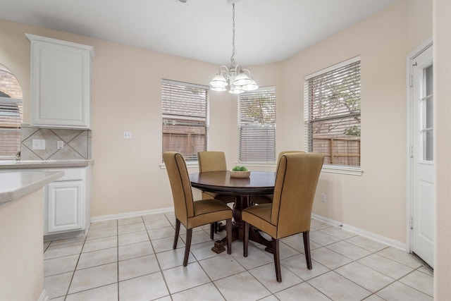 dining space featuring a notable chandelier and light tile patterned floors