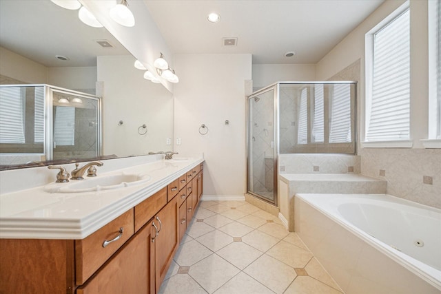 bathroom with tile patterned floors, vanity, and shower with separate bathtub