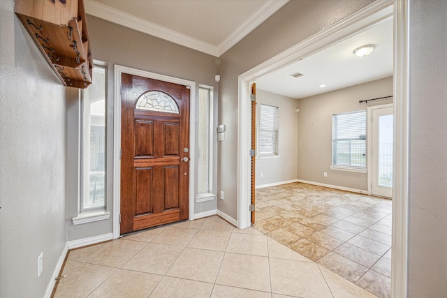 entryway with ornamental molding and light tile patterned floors