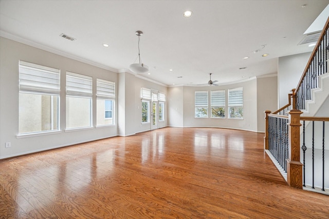 unfurnished living room featuring ornamental molding, ceiling fan, and light hardwood / wood-style floors