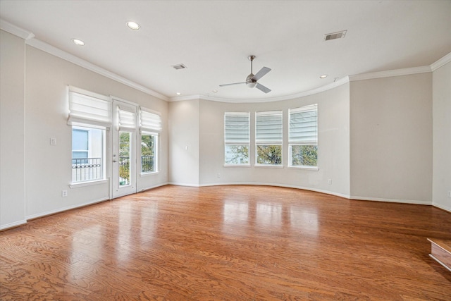 spare room featuring crown molding, hardwood / wood-style floors, and ceiling fan