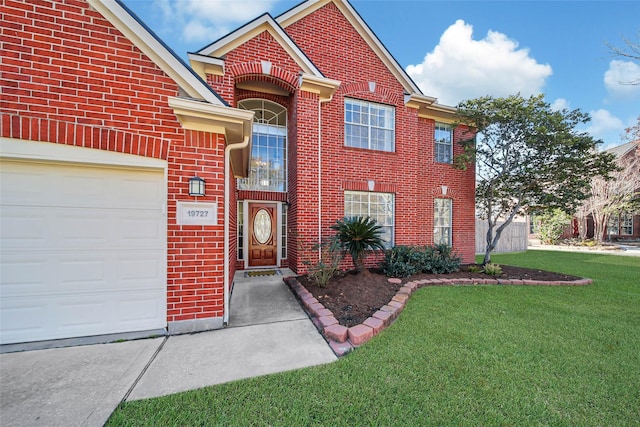 view of front of home with a garage and a front lawn